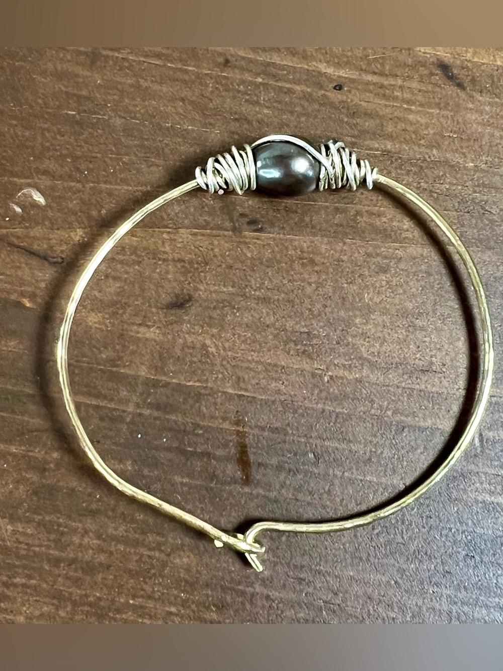 wire-wrapped single pearl bangle bracelet.
